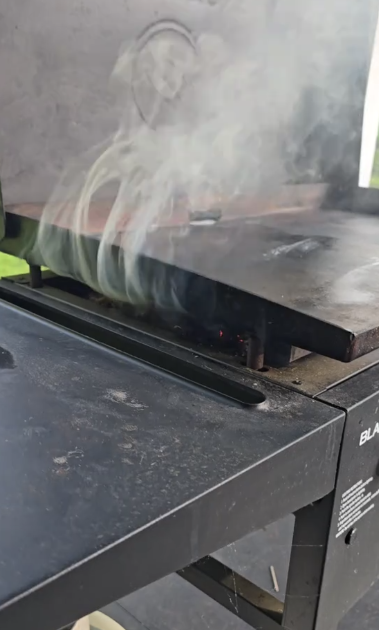 black grill with smoke
